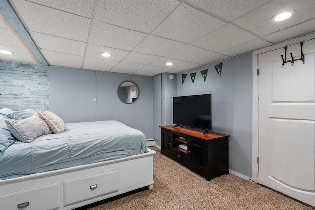 bedroom with recessed lighting, a paneled ceiling, light colored carpet, a baseboard radiator, and baseboards