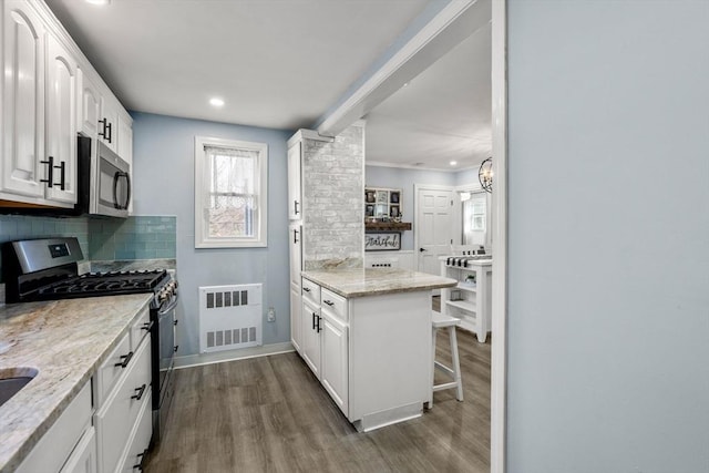 kitchen with visible vents, white cabinetry, appliances with stainless steel finishes, backsplash, and dark wood finished floors