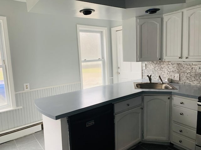 kitchen featuring sink, a baseboard heating unit, a wealth of natural light, and dishwasher