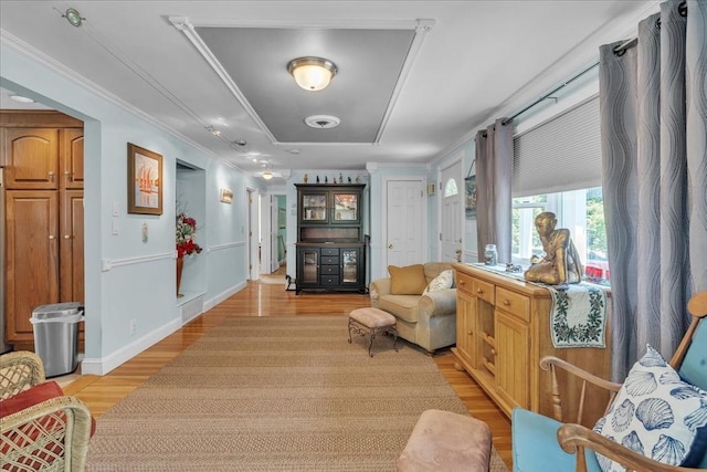 33 Dean St, Norton, MA 02766 - living area with light wood-type flooring, a tray ceiling, and ornamental molding