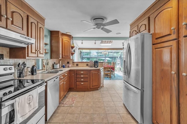 33 Dean St, Norton, MA 02766 - kitchen featuring appliances with stainless steel finishes, under cabinet range hood, a ceiling fan, brown cabinetry, and a peninsula