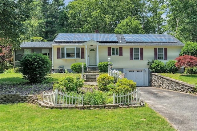 33 Dean St, Norton, MA 02766 - view of front of property with asphalt driveway, an attached garage, solar panels, and a front yard