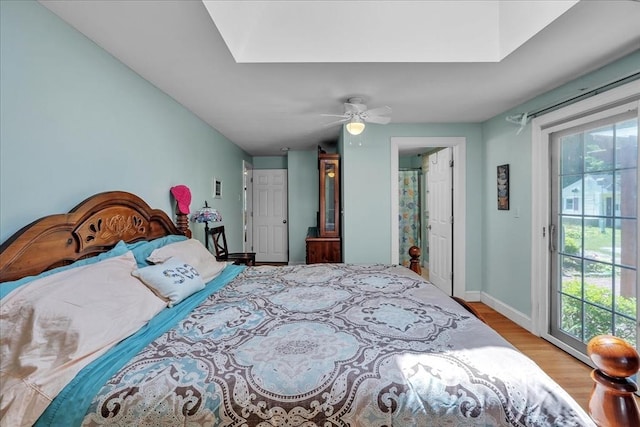 33 Dean St, Norton, MA 02766 - bedroom featuring access to exterior, wood finished floors, a skylight, and a ceiling fan
