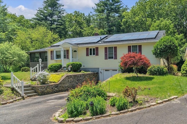 33 Dean St, Norton, MA 02766 - ranch-style home with an attached garage, solar panels, asphalt driveway, and a front lawn