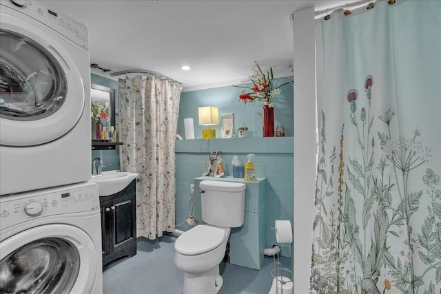33 Dean St, Norton, MA 02766 - bathroom with stacked washing machine and dryer, finished concrete flooring, a shower with shower curtain, vanity, and recessed lighting