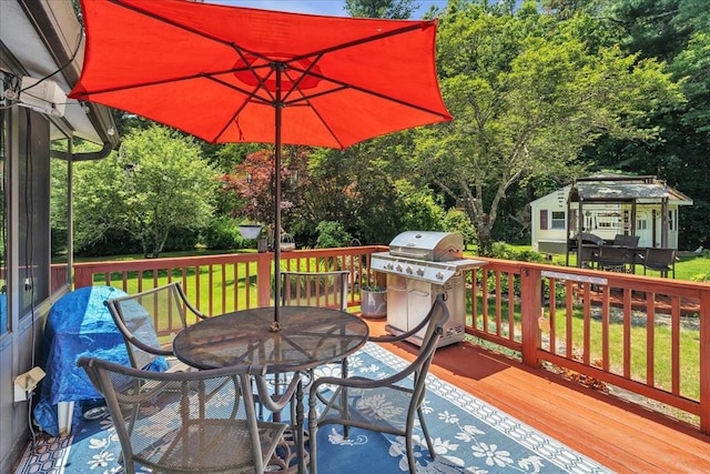 33 Dean St, Norton, MA 02766 - wooden deck featuring a grill, outdoor dining area, and view of wooded area