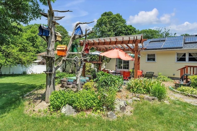 33 Dean St, Norton, MA 02766 - back of property featuring a pergola, roof mounted solar panels, and a patio area