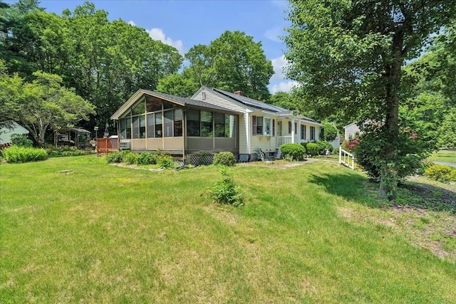33 Dean St, Norton, MA 02766 - view of front of home with a sunroom, a front yard, and solar panels
