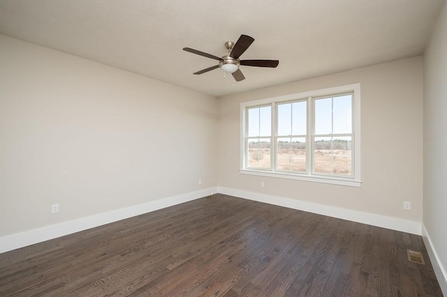 spare room featuring ceiling fan and dark wood-type flooring