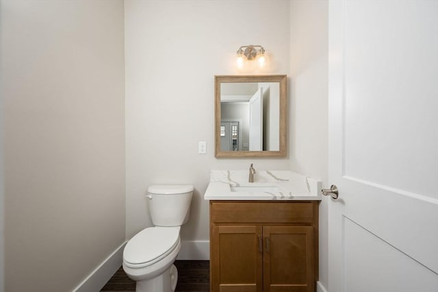 bathroom with vanity, hardwood / wood-style flooring, and toilet