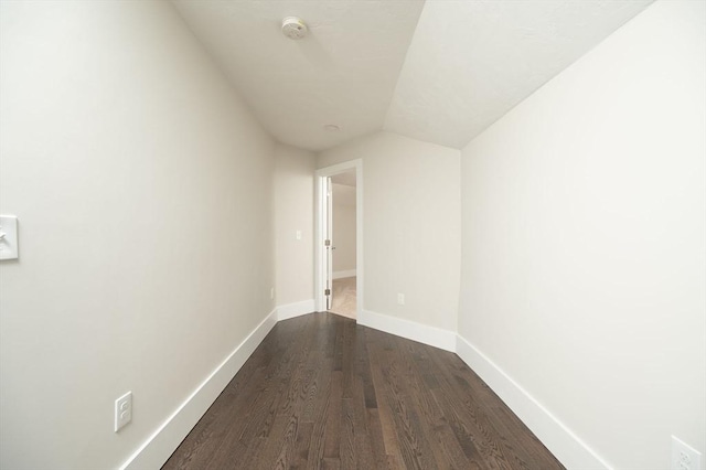 hall featuring vaulted ceiling and hardwood / wood-style flooring