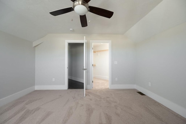 additional living space featuring ceiling fan, lofted ceiling, and light carpet