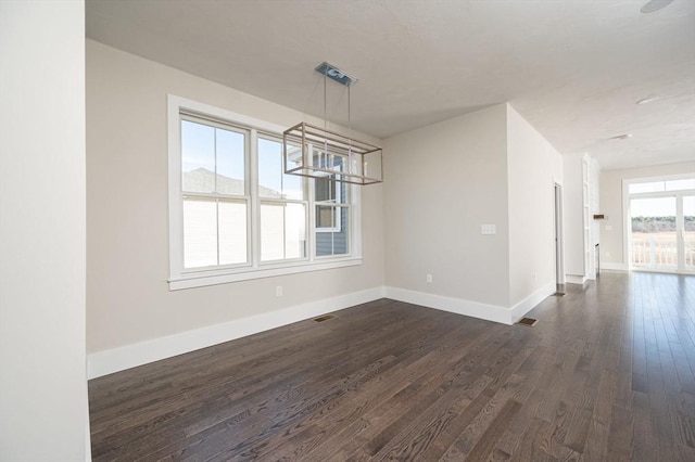 unfurnished dining area featuring dark hardwood / wood-style flooring and a wealth of natural light