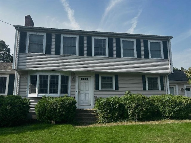 46 Frairy St, Medfield, MA 02052 - colonial-style house featuring a chimney and a front lawn