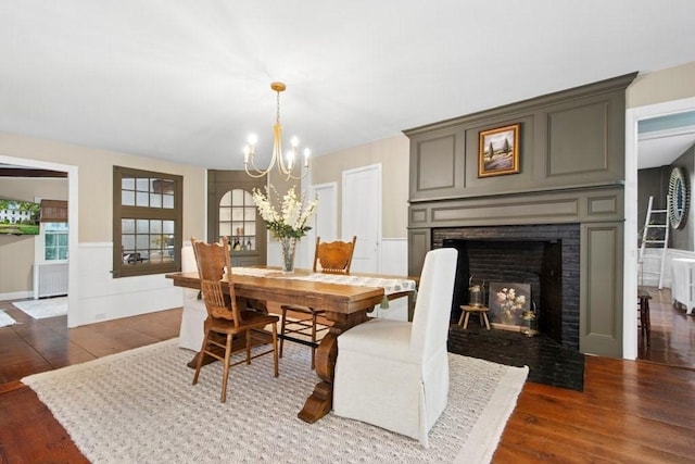 38 S St, Grafton, MA 01519 - dining space featuring wood finished floors, radiator, a chandelier, and wainscoting