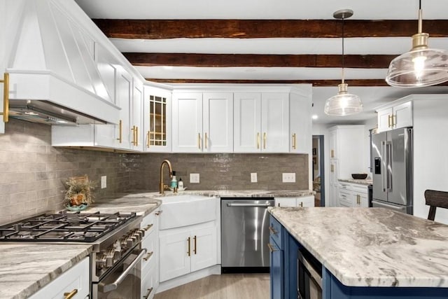 38 S St, Grafton, MA 01519 - kitchen featuring high quality appliances, premium range hood, blue cabinetry, white cabinetry, and beamed ceiling