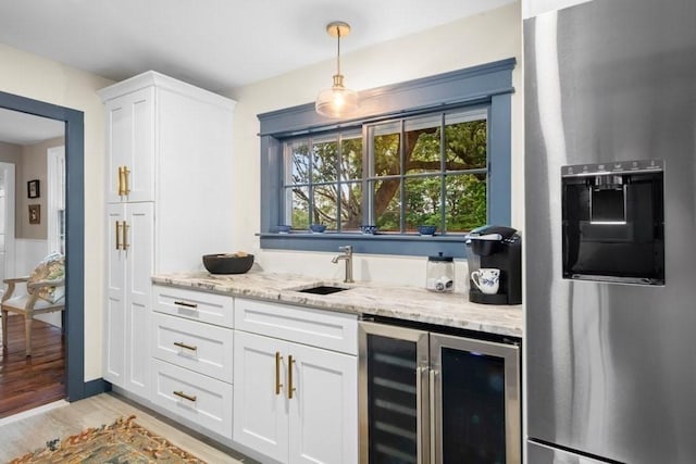 38 S St, Grafton, MA 01519 - indoor wet bar with beverage cooler, stainless steel fridge with ice dispenser, light wood-type flooring, and decorative light fixtures
