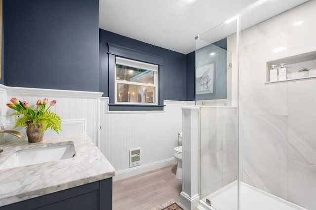 38 S St, Grafton, MA 01519 - bathroom with vanity, a shower stall, heating unit, wood finished floors, and wainscoting