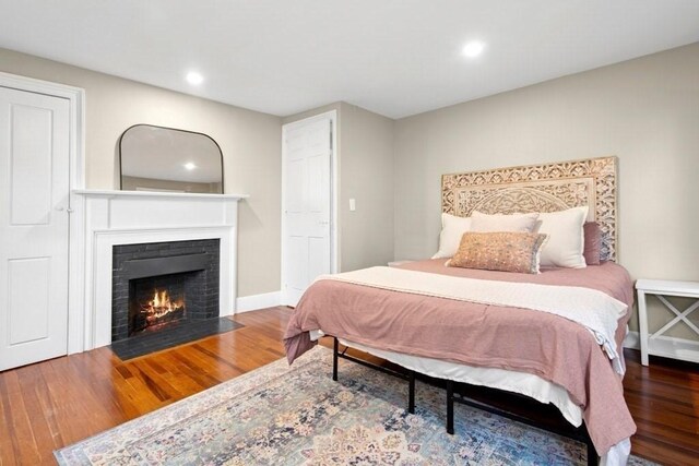 38 S St, Grafton, MA 01519 - bedroom with wood finished floors, a fireplace with flush hearth, and recessed lighting