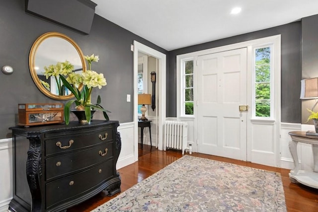 38 S St, Grafton, MA 01519 - entrance foyer featuring radiator heating unit, a wainscoted wall, dark wood-style floors, and a decorative wall