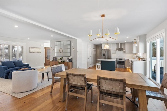 dining room with a notable chandelier and light hardwood / wood-style flooring