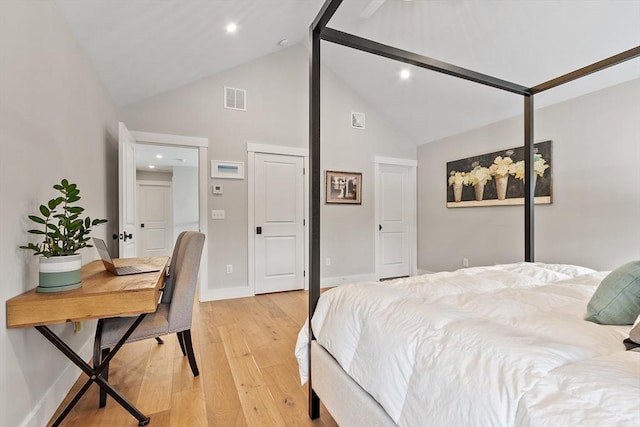 bedroom featuring high vaulted ceiling and light hardwood / wood-style floors