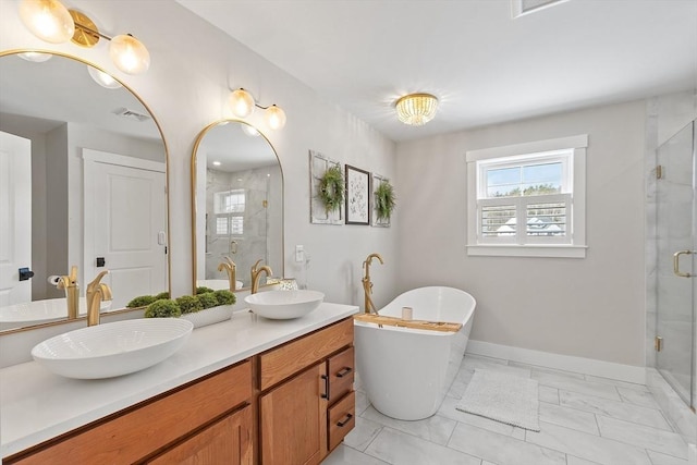 bathroom featuring vanity and separate shower and tub