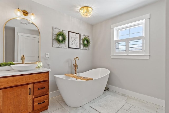 bathroom featuring vanity and a tub to relax in