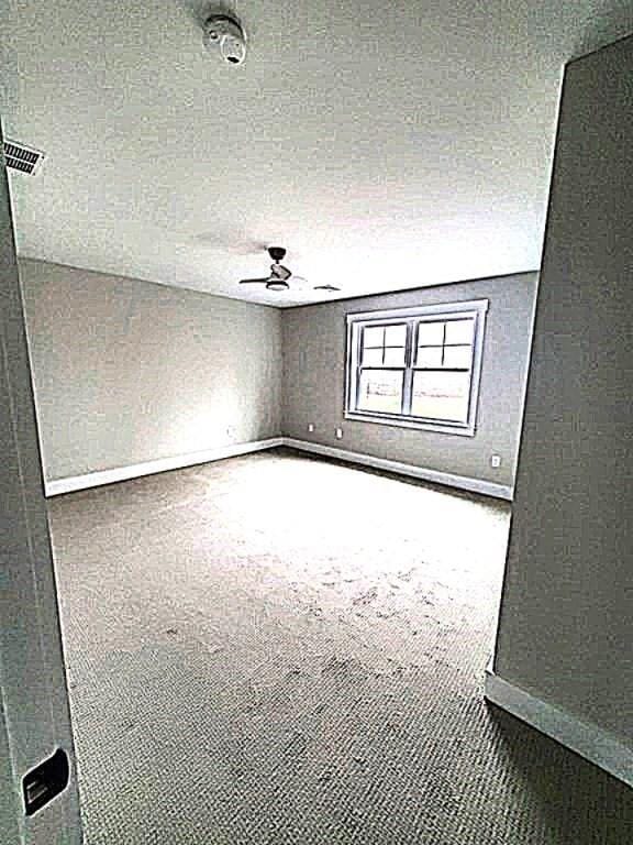 carpeted empty room with a textured ceiling