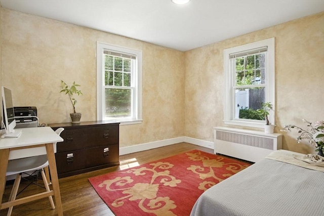 182 Winn St, Woburn, MA 01801 - bedroom featuring radiator, multiple windows, wood finished floors, and a desk