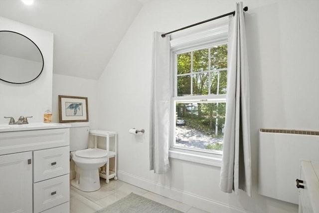 182 Winn St, Woburn, MA 01801 - bathroom with vanity, vaulted ceiling, and radiator heating unit