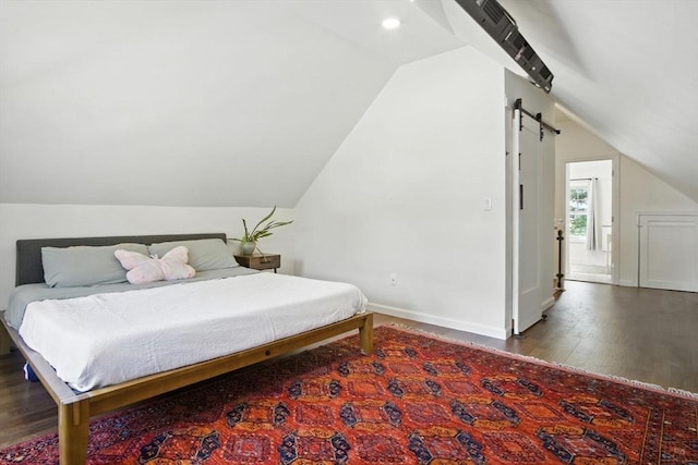 182 Winn St, Woburn, MA 01801 - bedroom featuring lofted ceiling, wood finished floors, recessed lighting, and a barn door