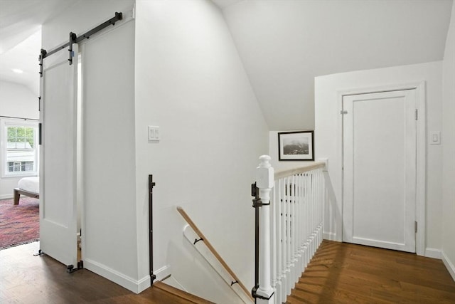 182 Winn St, Woburn, MA 01801 - corridor featuring an upstairs landing, a barn door, wood finished floors, and lofted ceiling