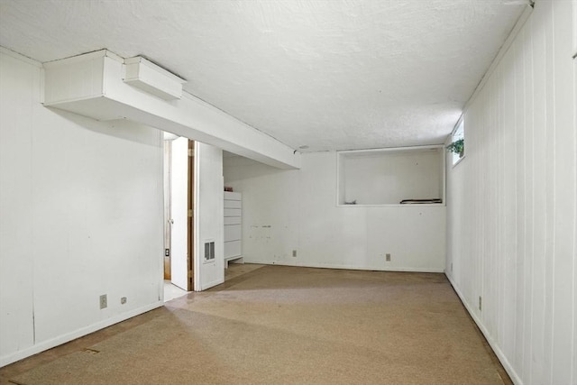 182 Winn St, Woburn, MA 01801 - below grade area with carpet floors and a textured ceiling