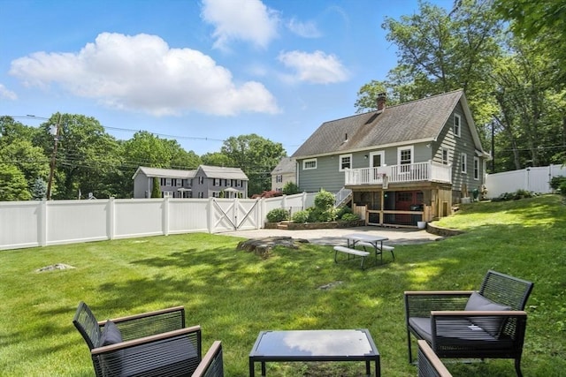 182 Winn St, Woburn, MA 01801 - rear view of house with stairway, a fenced backyard, a deck, and a chimney