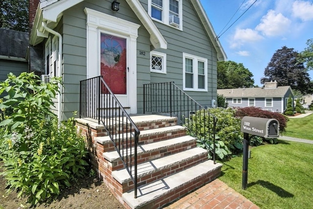 182 Winn St, Woburn, MA 01801 - view of front facade featuring a front yard and cooling unit