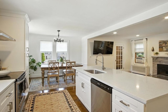 182 Winn St, Woburn, MA 01801 - kitchen featuring appliances with stainless steel finishes, dark wood finished floors, radiator, light countertops, and a chandelier