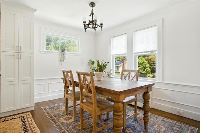 182 Winn St, Woburn, MA 01801 - dining room featuring a chandelier, ornamental molding, dark wood-type flooring, a decorative wall, and wainscoting