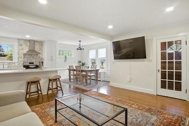 182 Winn St, Woburn, MA 01801 - living room featuring dark wood finished floors, plenty of natural light, recessed lighting, and a chandelier