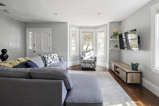 living area featuring baseboards, dark wood-style floors, and recessed lighting