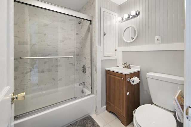 bathroom with toilet, tile patterned floors, shower / bath combination with glass door, and vanity