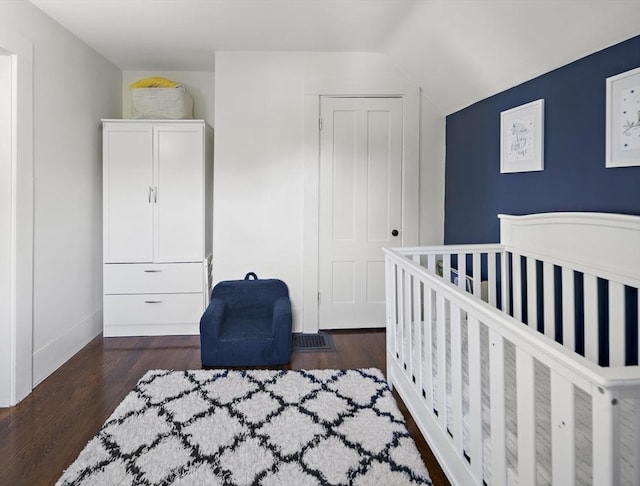 bedroom with wood finished floors and baseboards