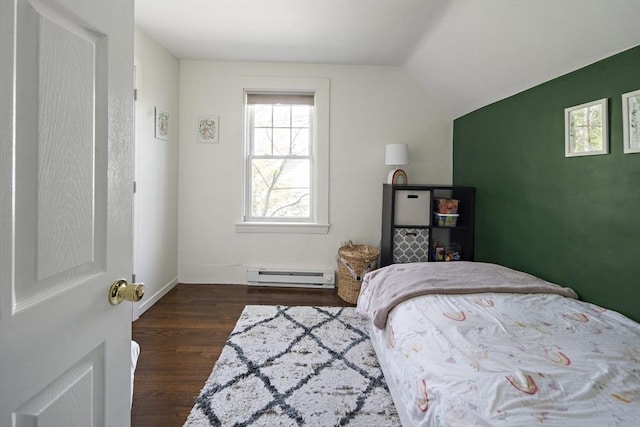 bedroom featuring a baseboard heating unit, wood finished floors, vaulted ceiling, and baseboards
