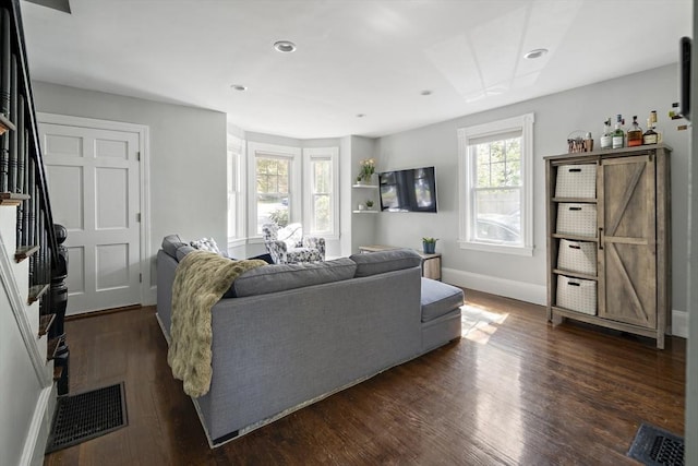 living room with dark wood-style floors, baseboards, stairs, and recessed lighting