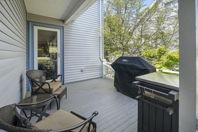 wooden deck featuring a grill