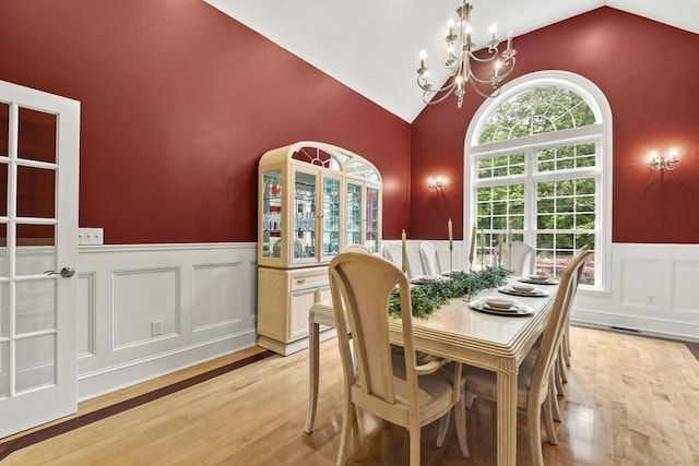42 High St, Freetown, MA 02702 - dining space featuring vaulted ceiling, a wainscoted wall, a chandelier, light wood finished floors, and a decorative wall