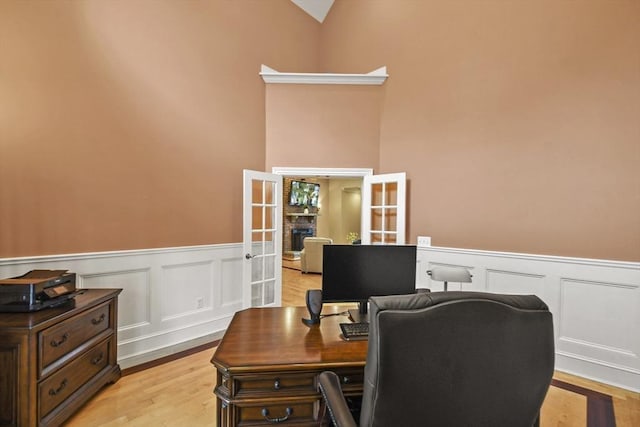 42 High St, Freetown, MA 02702 - office space with french doors, a wainscoted wall, light wood-style floors, a decorative wall, and lofted ceiling