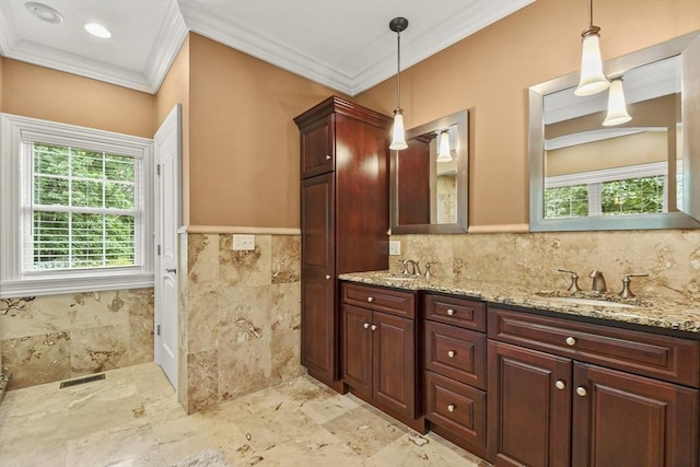 42 High St, Freetown, MA 02702 - bathroom featuring ornamental molding, double vanity, plenty of natural light, tile walls, and wainscoting