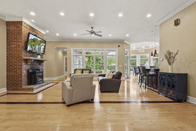 42 High St, Freetown, MA 02702 - living area with ceiling fan, crown molding, recessed lighting, wood finished floors, and a wood stove