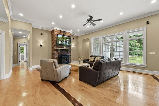 42 High St, Freetown, MA 02702 - living area with light wood-style floors, a ceiling fan, ornamental molding, recessed lighting, and a brick fireplace